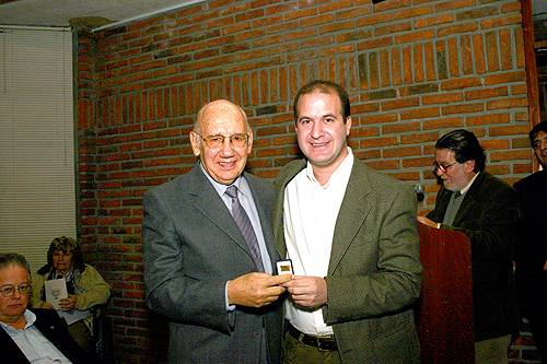 El Dr. Rodolfo Manuel Panizza recibe de manos del Dr. Julio Trostchansky su Distinción Sindical.